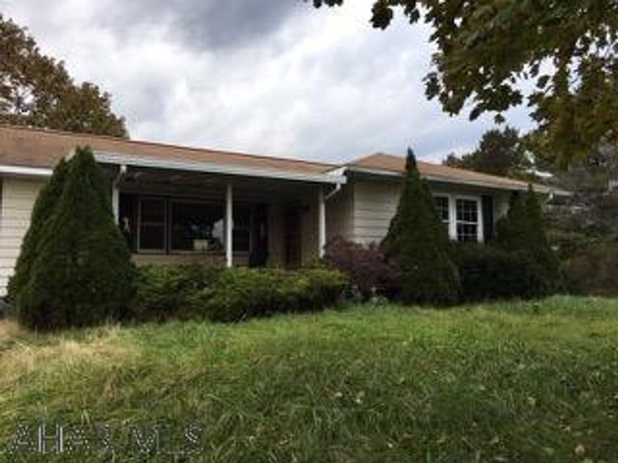 LOCATION LOCATION LOCATION!  This is a sprawling rancher in need of total renovation.  It has been abandoned and vandalized.  IT IS CASH OR RENOVATION LOAN ONLY!!!  Great views and quiet location make this quite the hidden treasure with so much potential.  There is a breezeway that connects the house and garage. Hardwood floors throughout and a basement that could be finished.  AS IS Sale Seller will make no repairs.!
