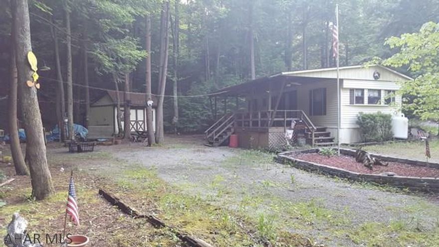 Park model camper on one lot inside Glendale Yearound. This park model is in a great private location. Located at the end of a dead end street, right beside a small stream. Deck attached to park model and a shed come with property.