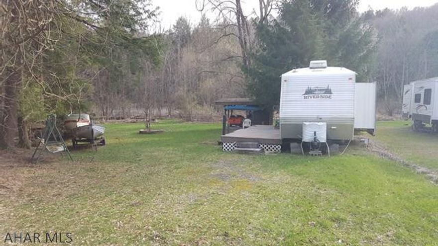 Vacant campsite in Glendale Yearound. Located very close to small pond in Dutch Run Campground. W/S, electric, deck already there. Ready to use right now. Glendale Yearound is a gated community located minutes from Glendale Lake and Prince Gallitzin State Park. Camper in pictures is NOT included. Owners may consider selling.