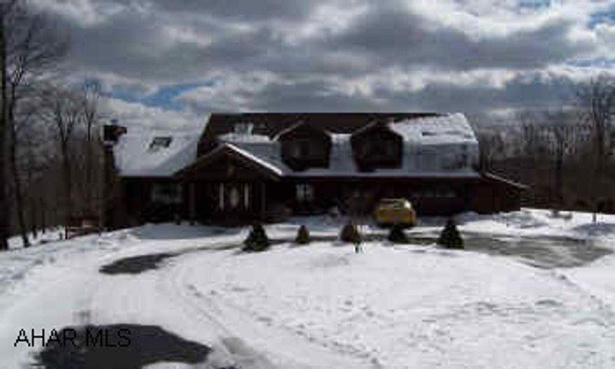 3500+/- square foot log home in  a private setting with beautiful mountain views!  This quiet retreat is situated on 33.3 acres with 6 bedrooms and 5 baths.Soundproof  family room in basement with wet bar and 1/2 bath.  Private master bedroom suite features a jacuzzi tub with italian marble steps, double shower and sinks, and laundry hookups.  Take in the view while enjoying a relaxing swim in the heated  inground pool.  2 car attached garage and 3 car detached garage.  Many added features call listing agent for more info. Qualified buyers only. Listing agent is related to seller.