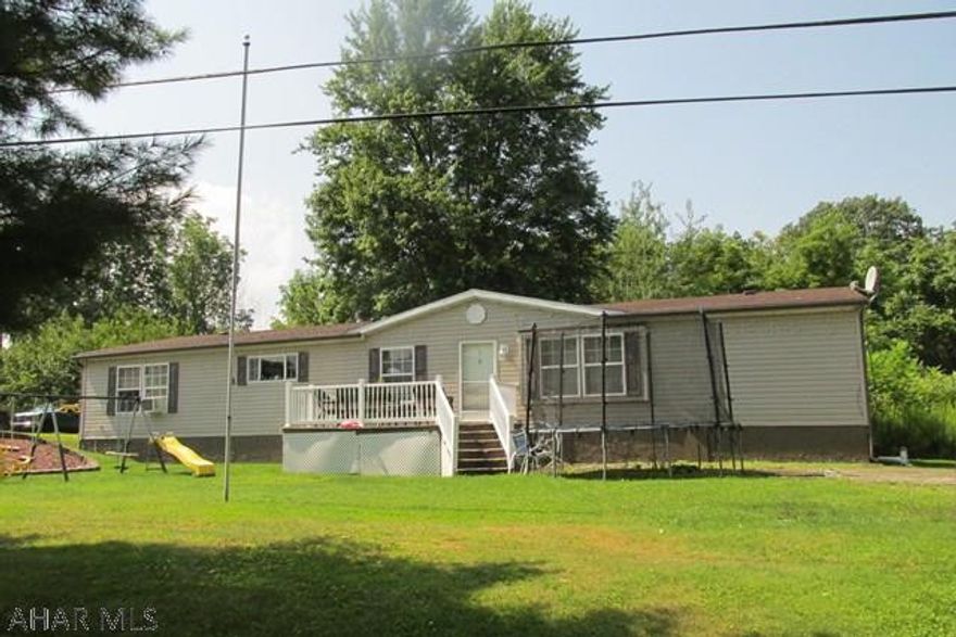 Lovely well maintained, Double wide 28 x 72 Redman/Shadowridge (1999), Lots of living space & bedrooms, lg. master w/ ensuite bath, whirlpool tub & separate shower w/ dbl sink, LR, DR, FR, Eat-in Kitchen, Full Bath, (new roof 2017), separate laundry area. Wood burning fireplace in Family Room w/ sliding door to deck. Aluminum carport-2 cars, 2 sheds. Survey-see documents.  As per lender title has been retired and property is on a permanent foundation, tongue and wheels removed.  Motivated Seller.