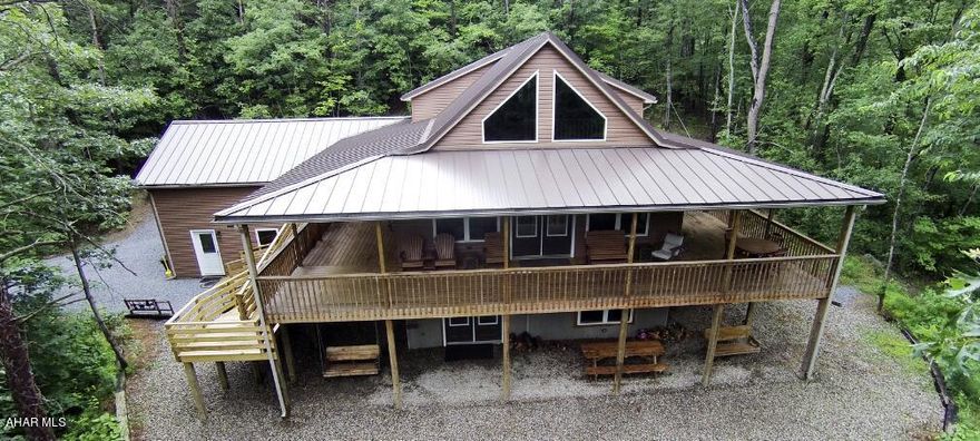 Known as the Chocolate Moose this stunning 5 bedroom 3.1 bath chalet is located 10 minutes away from Raystown Lake.  Whether you are looking for your own private getaway or a high-end rental this tranquil property has it all.  This is a turn key property is ready for your next endeavor.  The interior offers an open floor plan with natural light and high end amenities.  This is a must see.