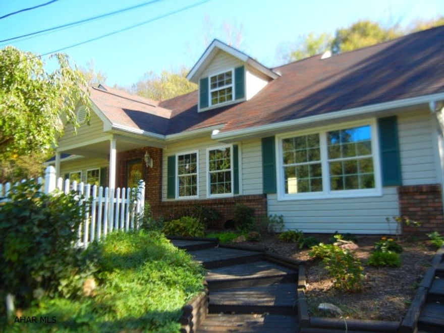 HOLLIDAYSBURG SCHOOLS...ON TOP OF THE WORLD AND SO SERENE! Awesome view from this 4 bed 2.5 bath that has been beautifully updated!  New baths and kitchen with granite, new roof, windows, central air, carpeting and flooring. 1st floor master suite enables one story living. Sun room and large family/living room with vaulted ceiling has floor to ceiling stone fireplace, skylights and tongue and groove ceiling are great for entertaining or relaxing.  The lot is over an acre and has 2 decks, a gazebo, firepit, bridge, large shed/workshop and lush landscaping. Very private and close to State Game Lands and horse riding trails!