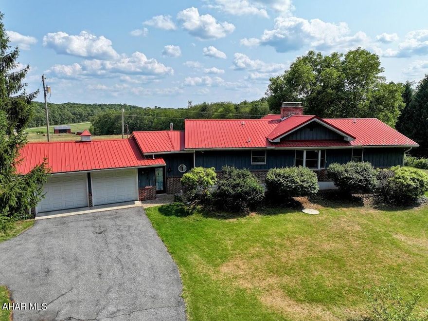 Take a look at this unique ranch style home located in Clearview Acres and just minutes from downtown Clearville. Enter into a large heated mudroom, conveniently adjoining the attached two-car garage, with access to a rear fenced dog run. Step up into the gorgeous galley kitchen with stone tile flooring and backsplash. From there you'll enter the open concept dining area into the living room with beautiful wood flooring, divided by a soaring brick chimney with propane stove. The living room has large windows with gorgeous views of the countryside. Just off the living room, you'll find an expansive owner's suite with 3/4 bath and walk-in closet along with a large sunroom that has another propane stove, views of the countryside and access to a cozy screened in porch. On the opposite side of the living room you'll find two additional bedrooms and a large 1/2 bath that has been converted to include a laundry area but could be turned back into a full bath. Basement has additional 1/2 bath w/separate shower, summer kitchen and woodburning stove. Anderson windows throughout and central air conditioning are among the other quality features of this home. The large yard with raised gardens, sheds and two-story garage with electric, wall unit A/C, heat and upper level room add to all this property has to offer. Country living at its best. Call to schedule your tour.