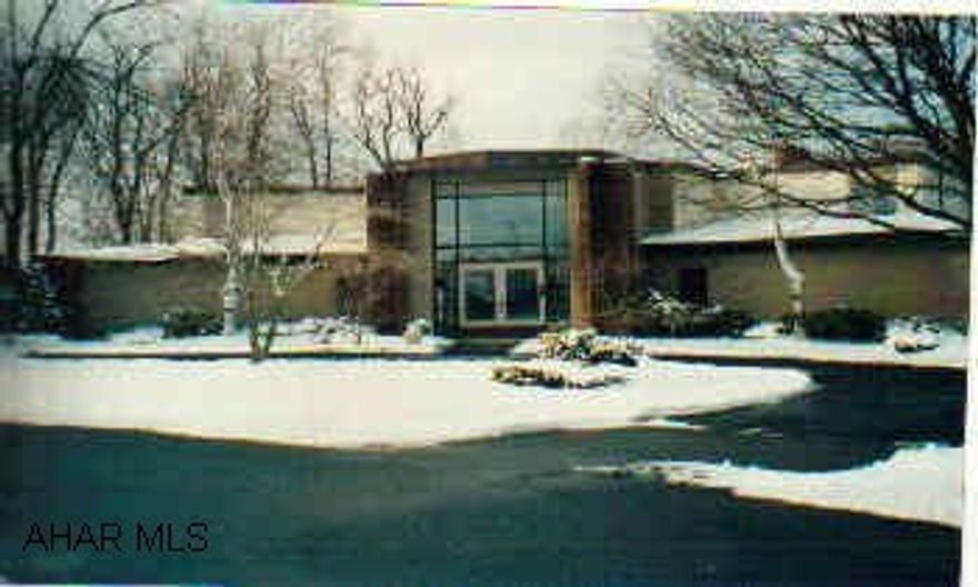 Exceptional home in a small town setting. The home was designed by noted architect Herman Petrolungo and has only had two famlies as owners. It has been extremely well taken care of and updated with modern appliances and fixtures.It is an open floor plan  Exceptional home in a small town setting. The home was designed by noted architect Herman Petrolungo and has only had two famlies as owners. It has been extremely well taken care of and updated with modern appliances and fixtures.It is an open floor plan with exceptionally large rooms that are open to nature by way of many windows across the first floor back of the home. The bedrooms and baths are extremely large and the master has a seperate dressing room. The most unique feature of the home is the indoor full court basketball court that can accomodate many different activities. There is a six person Swedish sauna, billiard room, oversized laundry, woodshop, planting room, 16 closets (not counted in the 30 rooms), a sixty foot patio, built in gas grille in the kitchen, and other special features. The property backs up on 100 acres of prime hunting land and deer and turkey are regular visitors.