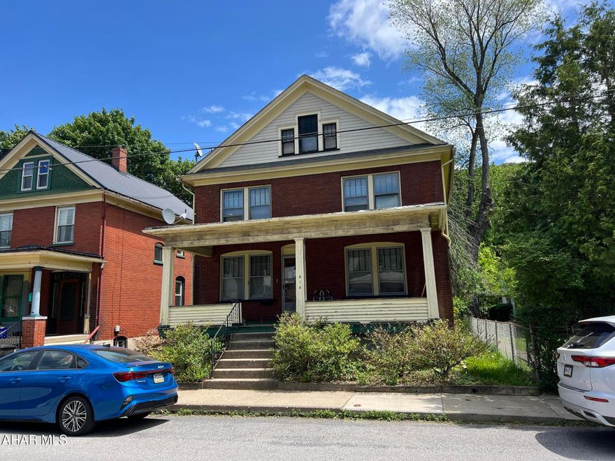 Solid, spacious brick home in need of your touch to bring it back to it's original beauty. Large living and dining rooms with hardwood floors, 3 bedrooms and a bonus room and enclosed upper and lower porches. Bring your imagination and make this your new home!