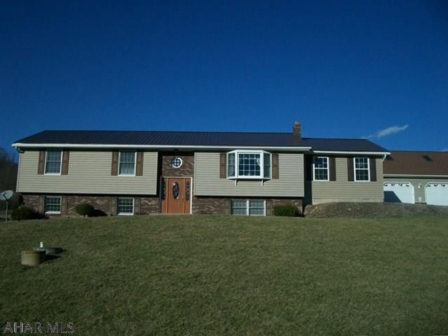 Magnificent mountain views from this rural raised ranch home.  Sit on the deck by the pool, watch the mountains, or sit at the fire pit .  Entertain with family and friends in the large kitchen that opens up onto the deck,in the sun room off kitchen,  or even in the downstairs family room.  This move in ready home has 3 bedrooms with a bonus room in basement that has a built in book shelf. Enjoy the convenience of central air and 3 heat sources, including the outside wood burning furnace. The 3 car heated garage has ample storage.  Camper parking with electric.  This home has all the little touches that make it a one of a kind home.  Come see it today.