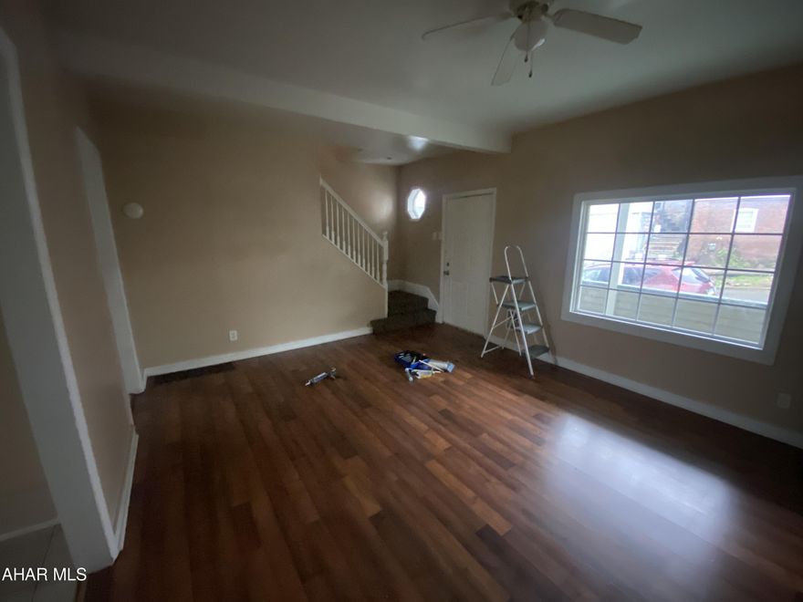 Calling all investors or first time home buyers! This home features a spacious living room with a separate dining room and plenty of windows for lots of natural lighting. The kitchen has plenty of cabinets for storage and overlooks the back porch and back yard. Upstairs you will find three bedrooms and a full bathroom. The attic is finished and would make for a perfect fourth bedroom, office or other bonus space!