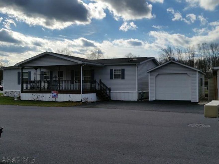 Beautiful 3 bedroom, 2 bath, Champion 32 x 56 double wide on corner lot, open floor plan, spacious rooms, master bedroom with walk-in closet and master bath with double bowl sinks, separate shower, and garden tub, kitchen with counter bar and island counter, skylights, formal dining room, front porch, and 1-car garage with blacktop drive. Monthly lot rent of $350 includes trash. Water and sewer runs $41.22/mo but will vary with # of people in home.  Estimated Reassessment Taxes for 2017 = $619.00.    #J-370