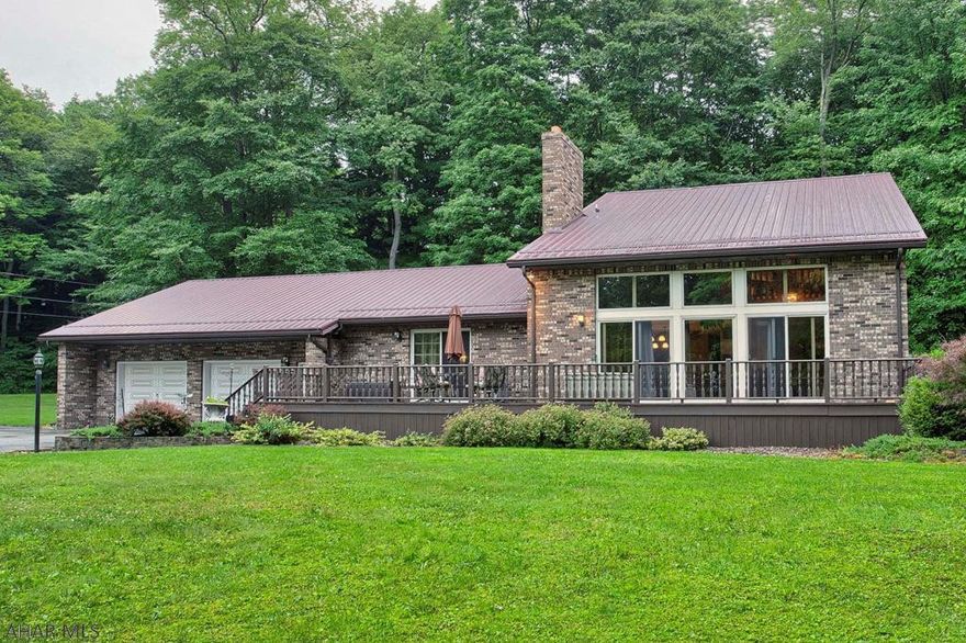 Hidden away on the fringe of the city is this charming 4 bedroom residence with a bonus room and balcony over looking the kitchen and beautiful outdoors. On the entry level, you will find a large family room complete with fireplace, duel sliding glass doors that open up onto the front and back porch, as well as a large eat-in kitchen with an additional living room. Two more bedrooms and a full bath with laundry,  make up the rest of this specious level. Upstairs features two large bedrooms with a master bedroom and private en suite. Beyond the glass entails two large entertaining decks and 7.3 acres of wooded land for remote privacy. Your family and loved ones will enjoy the spacious yard, perfect for family gatherings and parties! Come take a look at this beautify... Don't miss out!