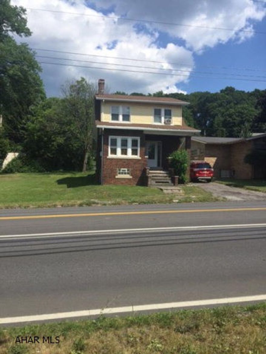 Charming brick home centrally located. Updated kitchen/bath with new tops and linenoleum flooring. Newer windows, light fixtures and carpet throughout. Hardwood floors under carpet. Private rear setting with covered porch. Alley access for off street parking.