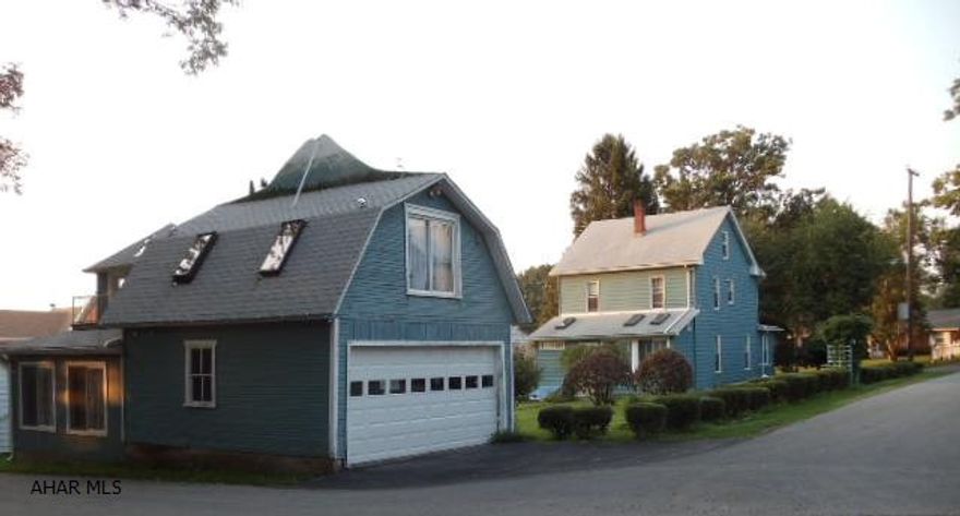 Nice 2 story home with detached heated summer building plus 2 car garage with finished room above.  Eat-in kitchen, heated sun-room, family room with pellet stove and enclosed front porchJ-087