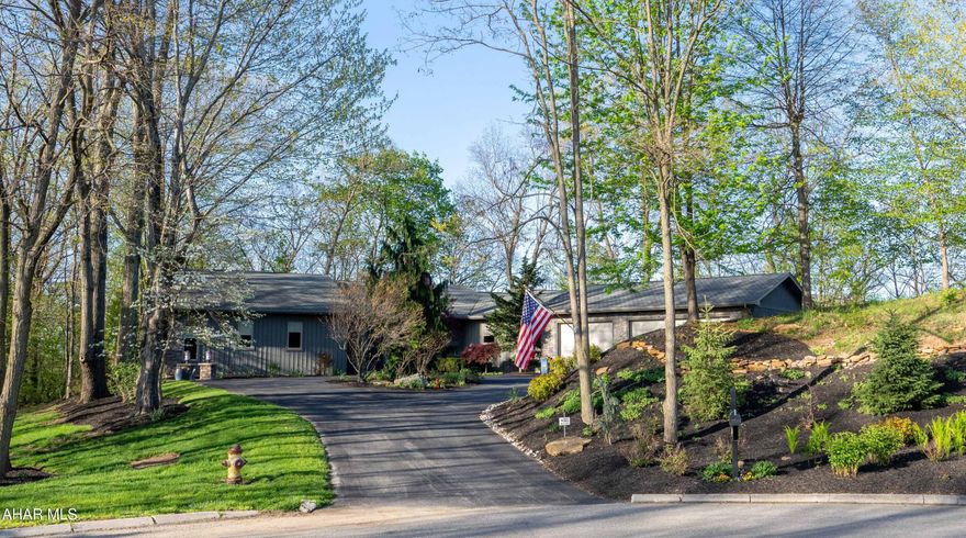 Tucked into a serene wooded lot, this stunning contemporary home offers the perfect blend of modern design and natural beauty all sitting on almost 2 acres at the end of the cul-de-sac. The open floor plan, covered with slate and bamboo floors, creates an inviting and seamless flow between the living, dining, and kitchen areas, all filled with natural light from expansive windows that frame the surrounding trees. Clean lines, vaulted ceilings, and quality finishes give the space a fresh, airy feel.

This contemporary kitchen is the heart of the home, featuring a sleek and functional design perfect for everyday living and entertaining. A large island bar with seating invites casual dining and conversation, while the gas cooktop and modern black stainless-steel appliances offer both style and performance. The kitchen flows seamlessly into the vaulted living room, where vaulted ceilings and a striking stone gas fireplace create a warm and inviting atmosphere that overlooks the patio area. Just a step down, a spacious family game room awaits—ideal for gatherings, play, or movie nights—making this open-concept layout as versatile as it is beautiful.

The private master bedroom suite offers a peaceful and spacious escape, designed with both comfort and function in mind. The room easily accommodates a king-size bed and additional space for a sitting area - perfect for reading, unwinding, or enjoying your morning coffee.  A highlight is the oversized walk-in closet, providing abundant storage and organization options. The adjoining master bath is equally impressive, featuring a dual-sink vanity, jet tub, separate step-in shower, and private water closet for added convenience and privacy, making this suite a true haven within the home.

Three private bedrooms offer comfortable and secluded retreats, perfect for guests or family members. One bedroom features its own en-suite bath with a step-in shower.

The home office offers a serene and productive environment, enhanced by a full wall of built-in cabinets and shelving that provide ample storage and display space. The abundance of windows frame peaceful wooded views, bringing in natural light and creating a backdrop for focused work or creative inspiration. The combination of functionality and scenic beauty makes this space ideal for remote work, study, or quiet retreat.

This home offers exceptional storage throughout, thoughtfully designed to keep everyday living organized and clutter-free.  The huge laundry room is no exception with not only an abundance of cabinetry, but an island workspace, and sink. It also serves as an entrance from the oversized 3 car garage which boasts radiant heat and storage units.

Step outside to discover a thoughtfully designed hardscape entertainment area—ideal for hosting gatherings or relaxing in solitude. Surrounded by the sounds of nature, this outdoor retreat features a stone patio, built-in gas fire pit and grill/bar area, creating an effortless extension of your living space into the great outdoors.

The property features top-tier mechanical systems, including four-zone radiant heat, central air conditioning, central vacuum, and pre-installed generator connection for added peace of mind.