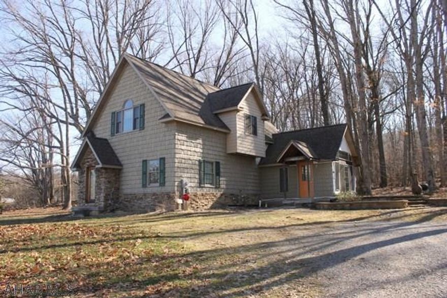 Absolutely beautiful woodwork and cathedral ceilings in this cozy home nestled on 2 private acres . The first floor has a den/office with doors to a patio.  Large laundry area and a bedroom with full bath.  There is a large room off the laundry area  that is wired and ready to make into a beautiful master bedroom and bath, or even 2 extra bedrooms. The 2nd floor has a large living area with kitchen, dining area and beamed vaulted ceilings.  Full bath and sitting nook on this floor as well.  Fantastic views from the 2nd floor. The seller put a lot of thought and love when building this home.  Call the listing agent today for your private showing!