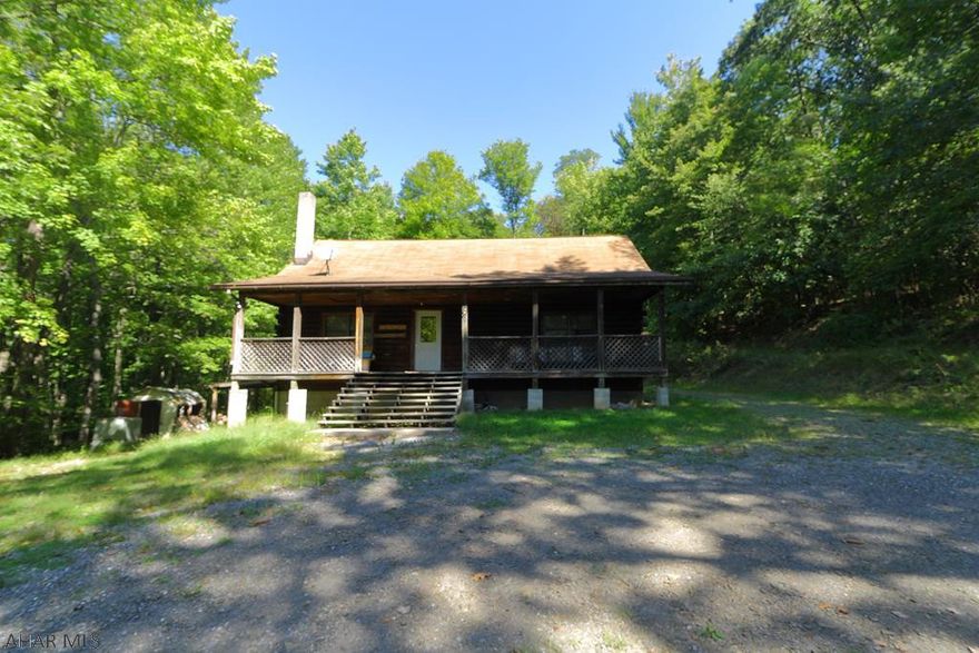 You have to see this delightful cabin home in Hollidaysburg, PA. There are 2 bedrooms on the main floor, along with a huge loft area. Enjoy the outdoors on the large porch, or on the deck! Bathrooms on main and second floor, with unfinished 3/4 bath in basement. This home sits on a large lot, surrounded by mature trees, and is ready for the next owners to bring it into the 21st century. Ask to see this house today!