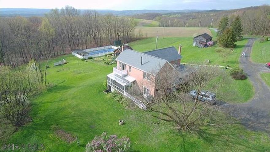 One of a kind brick farmhouse nestled on 85 acres in the mountains of Bedford County PA.  The ground offers lots for the outdoor enthusiast including: beautiful mountain views, walking trails through the woods, a multi-level tree house, 25'x50' pool with pergola, and a full gardening house.  The house is a full 4 bedroom, 4 full bath.   First floor includes and eat-in kitchen, main dining room as well as a spacious living room, w/ fireplace, that opens to a recently updated solarium.  Lower level includes a family room with wood stove as well a full bath.  Property is within 30 minutes of multiple state parks and skiing as well as easy access to route US 30, I70, PA turnpike and roughly 2 hr drive to the DC and Pittsburgh areas.