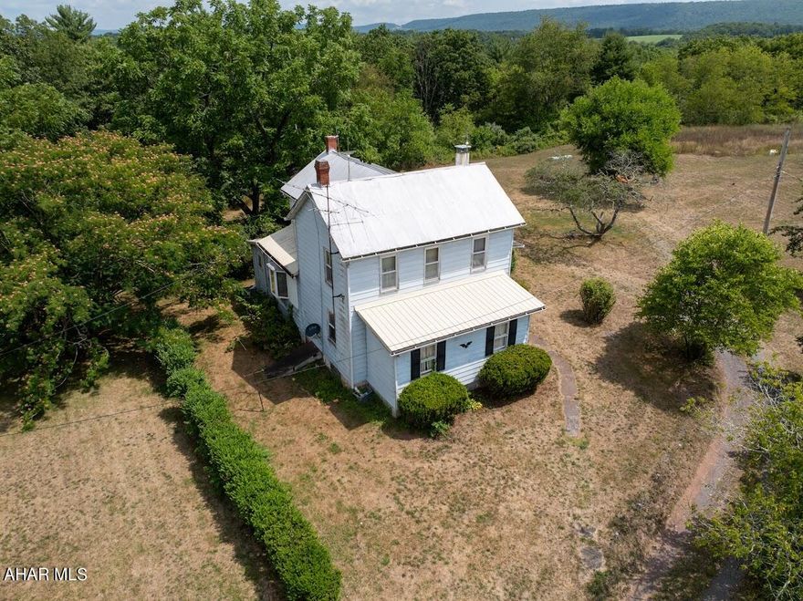 Do you enjoy hunting, fishing, or simply unwinding in the great outdoors? 
Then you'll love this charming farmhouse situated on 28 +/- acres of land. Brush Creek frontage state stocked trout stream, abundance of deer, turkey and other wide life. The first floor boasts a spacious kitchen, living room, bathroom, and laundry room. Additionally, there is a versatile room that was previously a dining area but is used as a fourth bedroom. While the second-floor features three bedrooms and a 3/4 bath.  
Outside, you'll discover a spacious two-story barn and a three-car garage, providing ample storage space for all your outdoor equipment and vehicles. 
This property offers the flexibility to serve as a full-time residence or a relaxing recreational getaway. 
Minutes from Breezewood Interchange.