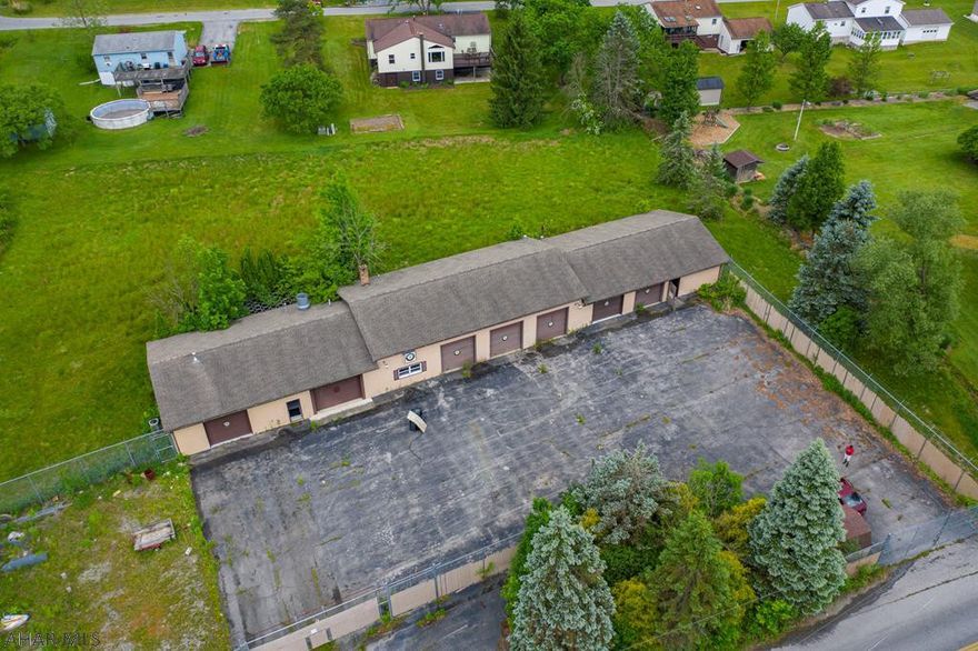 The site has access to all public utilities. A small portion of the subject is in the 100-year flood plain. The subject improvements are NOT in the flood zone. Zoning Residence R-1A (The property has a variance granted for an Equipment and Material Storage Building. For more information about the variance please reference the "other documents") The property has an open garage area with seven garage bays. One restroom. One bay keyed separately has track lighting, painted drywall, and sealed concrete. 200 amp service. To find out if your proposed use fits please reference the "Other Document".