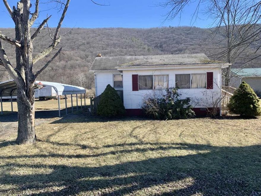 This cozy cottage style home has a wealth of possibilities.   Inside has been remodeled.  Updated kitchen and bath. Beautiful hardwood floors.   Exterior does need some work.  This would make a great starter home or rental property.     Or, that great little weekend getaway cottage.  Peaceful setting.  Handicap ramp included as well as a double car port. Priced to sell.  Don't miss this one.