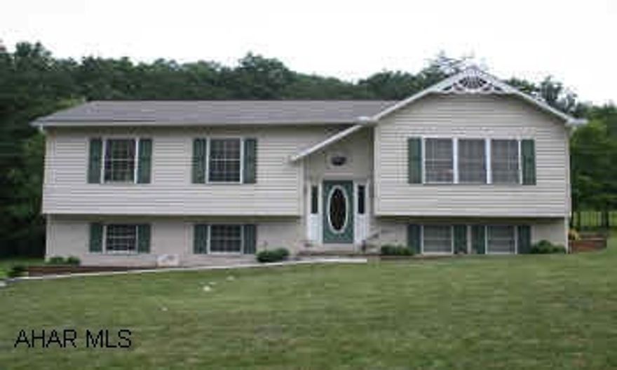 Striking Brick/Vinyl Raised Ranch home located on 1.34 acres in great neighborhood. Quiet street; large yard w/fenced play area and stone edged garden. Woodland views from back deck. Near schools. 2-car garage. Carpet, vinyl, laminate flooring.