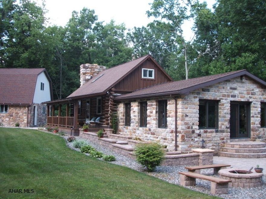 WOW! Breathtaking Property.  Log and stone home on 2.7 private acres.  Spectacular Views.  Close to hunting and fishing.  Minutes from Raystown Lake. Gorgeous stone patio for entertaining. Trickling waterfall. Amazing landscaping surrounds the entire home.  Sit in the hot tub on back deck and watch the wildlife.  2 car detached stone garage with finished 2nd floor. Finished basement with wet bar (more entertaining!) Great Room with vaulted ceilings and year round panoramic views.  Stone fireplace in Living Room.