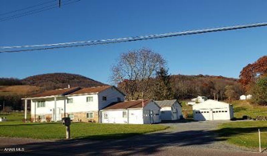 Beautiful vinyl-sided 3-bedroom 1-bath bilevel with integral and attached garages + 2 spacious outbuildings = total 8-car garage on 48.552 Acres. J-607