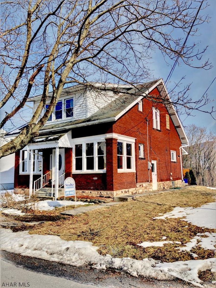 There's no place like warm cozy HOME! The inviting character of this place is missing only a family to share it. This beautiful brick home is nestled on over 3/4 of an acre with a gorgeous covered stamped concrete patio and a deck to enjoy. The spacious kitchen has cabinets galore and plenty of counter space.  Fridge, oven, dishwasher, garbage disposal...already in place.  Living room and dining room are so charming, both with stunning hardwood floors and big windows that leave in SO much natural light.  New hot water boiler will keep you toasty while keeping the gas bill low. 3 bedrooms upstairs are all spacious and all have Walk in closets and hardwood floors. Off street parking to left of house.  This house has so much charm, you really need to see it for yourself.