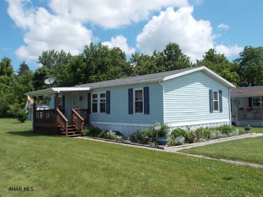 Extremely well maintained Doublewide with nice lot. Front and back covered porches - great for relaxing. All appliances stay. Lots of updates - newer windows. Vaulted ceiling in living room. Shed with electric and shelving. Lot rent is $350.00/mo. includes trash and road snow plowing. Water/Sewer bill to be calculated on an individual lot basis.