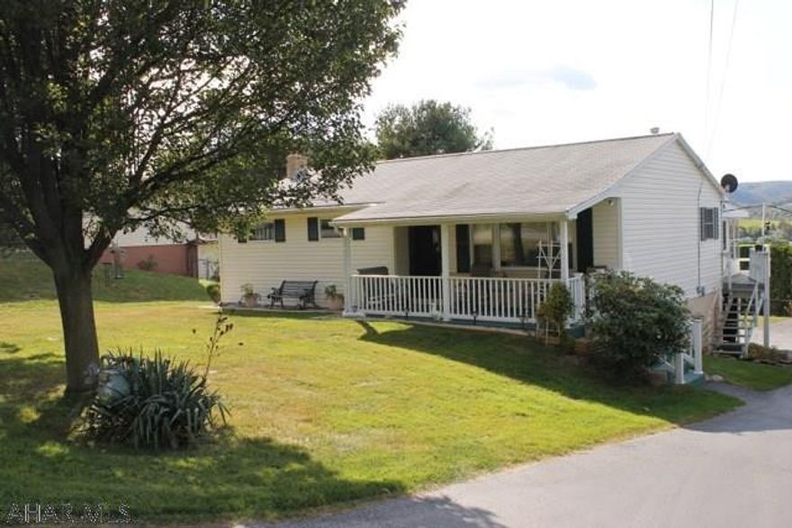 Enjoy the privacy of this 1 story home on over 1/4 acre, flat lot. Garage space for 4 cars...plus a carport! You will love the covered porch, the enclosed sunroom, the hardwood floors, and the beautiful country setting. Please call the listing agents to tour this property soon.  It should sell quickly.