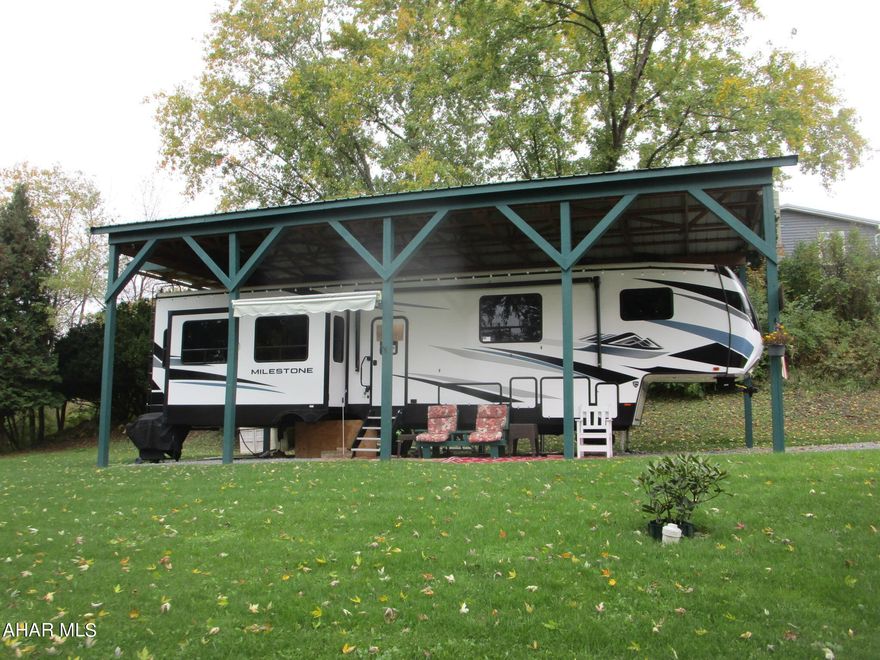 Are you looking for a private place to camp, close to fishing, hunting, hiking and other outdoor sports?  Do you need room for the family to enjoy outdoor living, a place to park your boat and a great firepit area to cook hot dogs and practice smore making?  Your search is over.  This property has over 1/2 acre of quiet - a cemetery is across the road.  The 2022 camper sleeps ten offers more of a glamping experience than just camping.  All of this with public water and sewer; no moving the camper to fill the water tank or pump out waste.  
Everything is set up and ready for you to enjoy.  Just add family , friends and fun.