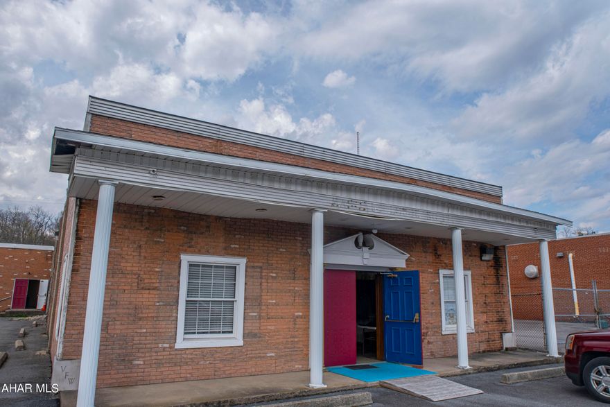 Great commercial property on busy E. Pleasant Valley Blvd located just outside of  downtown Tyrone. This property sits next to major factories and businesses and offers more than 5000 square feet of space to use as a warehouse, social hall or you can remodel-to-suit. Building currently has a kitchen, bathrooms (including handicap accessible) and two large rooms that were recently updated plus a large paved parking lot with lots of spaces.