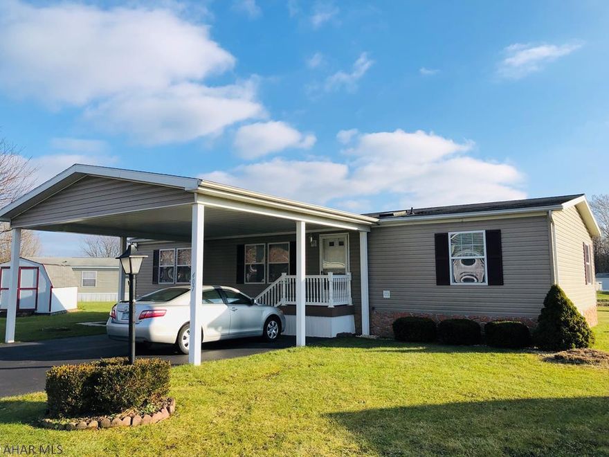 Not your average mobile home! This home offers many upgrades including drywall in the living room, dining room, and 3 bedrooms. Beautiful open concept living areas with sliding glass door off dining room that leads to a maintenance free composite deck. Tons of light with the skylights and windows. Very large kitchen with lots of storage and counter space. Master bedroom is spacious with walk-in closet and large bath. Off street parking with a vinyl carport that fits 2 cars...keeping you out of the weather. This home is in immaculate condition and is move in ready. Don't wait to see it in person!