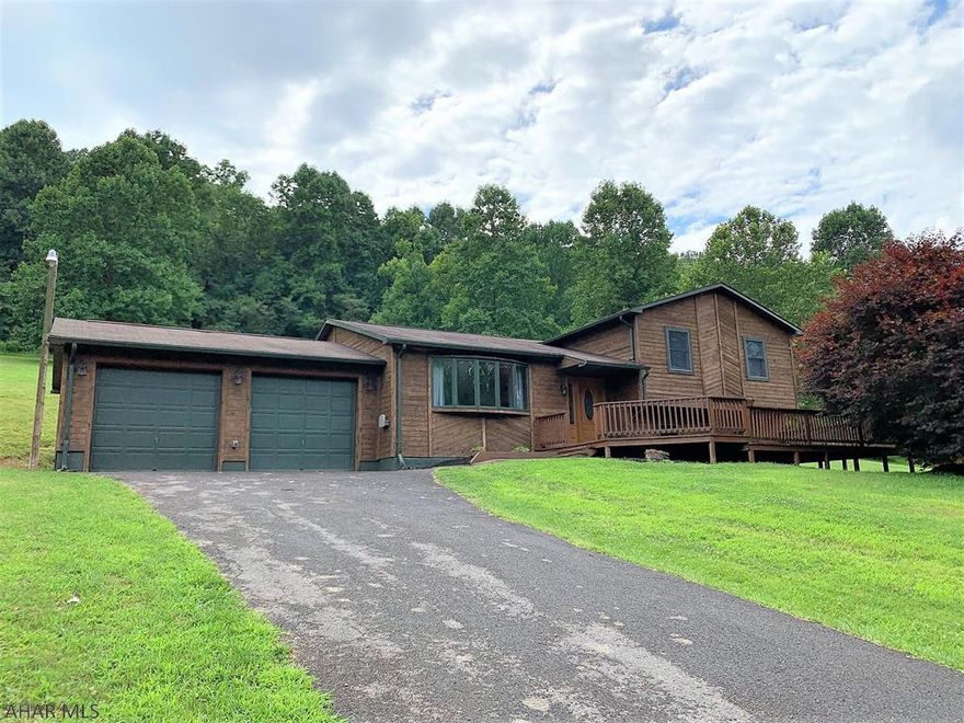This property offers 31.44 acres resting in a serene setting w/ Evitts Creek flowing through. Very private setting, peaceful views, open & wooded land, & a brand new 50-ton concrete bridge installed. The cedar sided home offers a large LR w/ a custom built-in bookshelf, kit. with corian counter tops, island & stainless steel appliances, & a dining area w/ french doors to the rear deck. Second level has a master suite w/ walk-in closet & m. bath, 2-additional bedrooms & a full bath. Lower level has a family room with wood burner, bedroom & another full bath. New Bosch heat pump with CA, electric BB & wood heat. 200-amp electric, private well and private septic. Large front deck for relaxing, multi-level rear deck, large storage & pole build. Close to Rocky Gap & State Lands. HOME WARRANTY!