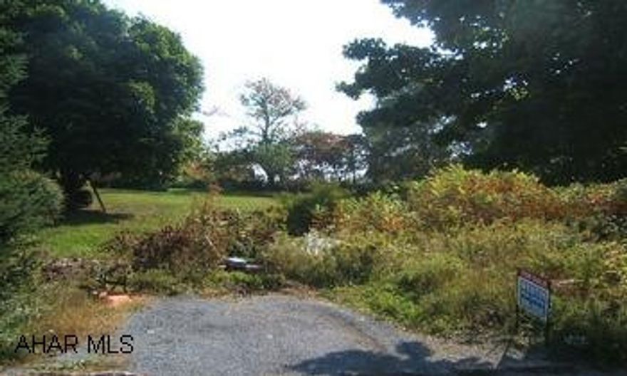 Vacant lot sloping up from road.  To the rt. of 604 Cleveland St.  Some grown up area at top and bottom.  Sewage right of way down left side of property, ending near parking area. City water & sewer taps available at front (pending boro approval).