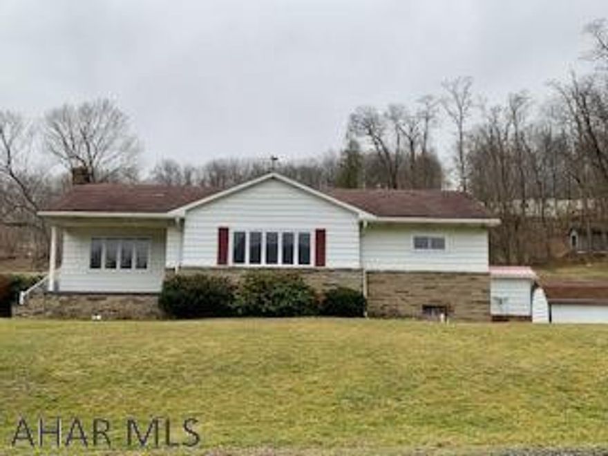 A well maintained home with its beautiful, original hardwood flooring, built in book cases, thermopane  windows, nice carport, 2 extra hook-ups for sewage and water. The basement has a canning kitchen, a bathroom and a spacious recreation room providing plenty of storage. Outside access from basement. Centrally located between Altoona and Bedford with easy access. This property comes with 3 sewer and water hook ups.  A must See!