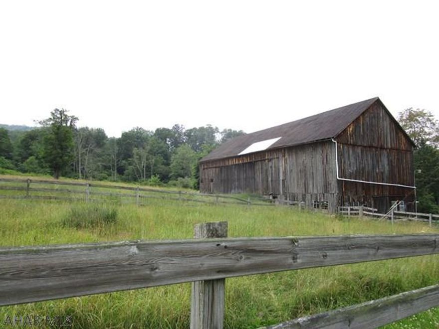 Looking for a nice home building site with acreage close to town?  Look no further!!  11 acres of open and wooded land, 40' x 80' post and beam bank barn with electric and water and nice views.  Situated less than two miles to downtown Bedford.  Public water on site, land would have to be percolation tested and approved for a private septic system.
