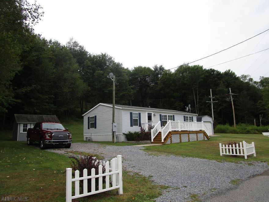 Well maintained double wide tied down with hurricane straps etc. The home contains 3 bedroom with 2 baths, living room, eat in kitchen and laundry room. Vaulted ceiling. Home is in good condition with many updates. Economical to heat with heat pump and oil fa. Home has 2x6 exterior wall framing. Front and rear decks, Central air, two sheds.