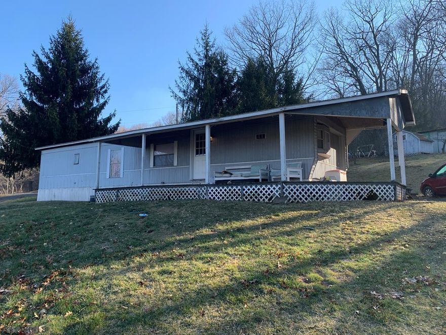 Two single wide mobile homes with a detached three bay garage and multiple outbuildings. Located not far from State Game Lands and Pike 2 Bike (Abandoned Pennsylvania Turnpike).