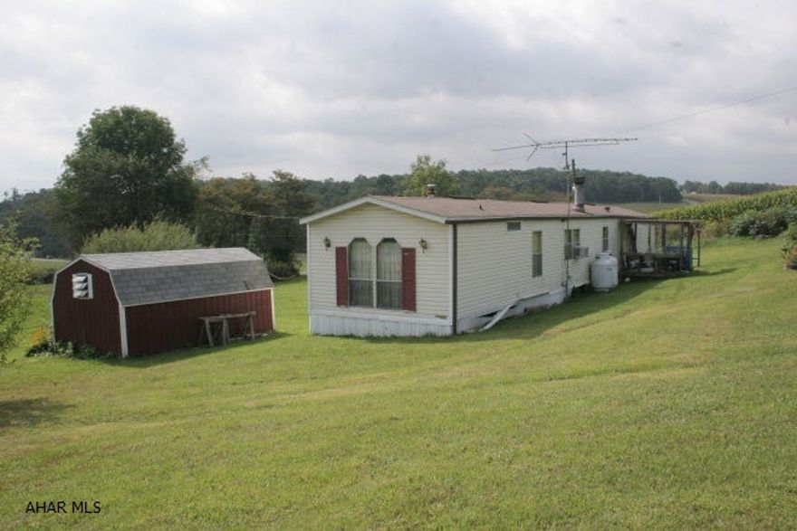 A 14X80 mobile home in a country setting with a little over an acre of ground. Private well and sand mound. The red shed on the property stays with the mobile home. Propane heated by forced air. Also has a living room fireplace that was originally gas but converted to wood. 3 bedrooms and 2 baths. An 'eat in' kitchen area. A nice starter home with a great piece of ground for someone hoping to do a future upgrade to a newer mobile home or a house.