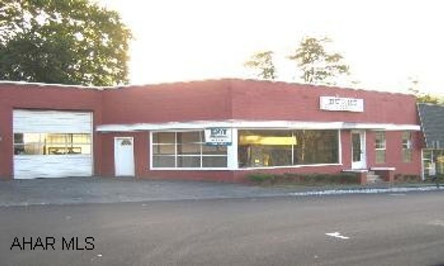 Commercial building with ten bay garage and showroom.  Large office.  Second floor apartment.