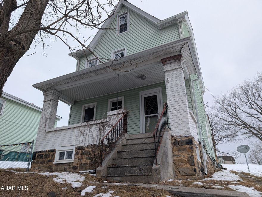 Juniata 2 story vinyl home is perfect for investors and handy persons everywhere! Includes 6 lots for nearly 1/2 acre! Close to Penn State Altoona. Large formal living room, formal dining, eat-in kitchen with large dining area plus rear mudroom. Three bedrooms upstairs (one w/ no closet) plus walk-up attic for storage. Thermo windows throughout, large front and rear covered porches. Property failed pressure test on plumbing. AS-IS sale. Seller will make no repairs.