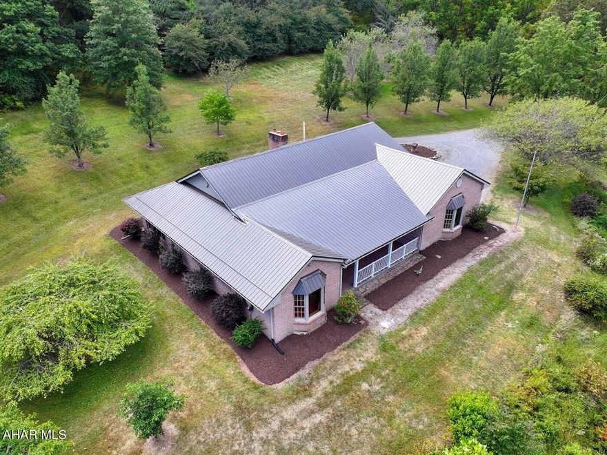 If you are looking for a HOME surrounded by wildlife and nature, this is it! Was lovingly built with high quality materials , all the woodwork was custom made.Home has only been lived in by the original owner. Very close to State Game Lands. Full Brick exterior, Brand New metal roof and New garage doors. Privacy and views out every window. Has a large living room with propane brick fireplace. Nice primary suite with walk-in closet and large bathroom. Relaxing all season sunroom. Don't miss the unique ceilings in living room and primary bedroom. Heat pump with oil back -up, central air. Large unfinished basement, garage has a 1/2 bath. Home has been full of lots of Love and Laughter. If having Peace and Tranqulity is on your wish list , look no further. Call today to take a look.