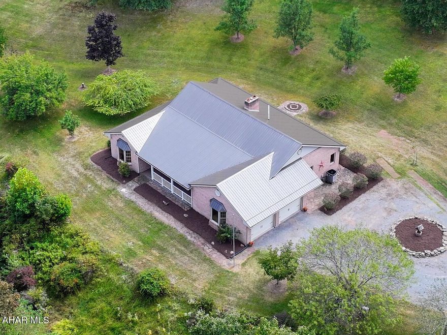 NEW PRICE!! If you are looking for a HOME surrounded by wildlife and nature, this is it! Was lovingly built with high quality materials , all the woodwork was custom made.Home has only been lived in by the original owner. Very close to State Game Lands. Full Brick exterior, Brand New metal roof and New garage doors. Privacy and views out every window. Has a large living room with propane brick fireplace. Nice primary suite with walk-in closet and large bathroom. Relaxing all season sunroom. Don't miss the unique ceilings in living room and primary bedroom. Heat pump with oil back -up, central air. Large unfinished basement, garage has a 1/2 bath. Home has been full of lots of Love and Laughter. If having Peace and Tranqulity is on your wish list , look no further. Call today to take a look.