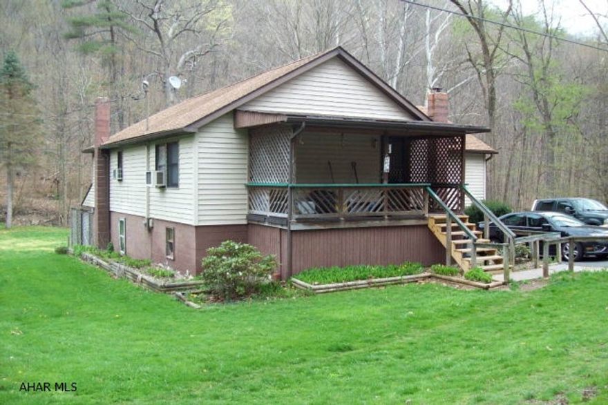 Enjoy country living in this 3-bedroom ranch home with private well and septic.  Large living room with built-in entertainment center, bonus room can be used as a den/study or sun room.  Finished basement has a large recreation room with wood burner, kitchen, laundry/storage,half bath and a workshop.