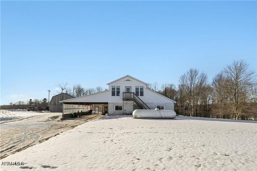 Looking for your space in the country?... This ONE has plenty of it! The home is over 5,500 SF and sits on 4 acres of flat land. It could be used as one massive home, keep part of it as a mother-in-law suite, or even live in one side and rent the other as a duplex. It's currently configured as two sides with each having a kitchen with pantry, living room, four bedrooms, and two baths as shown on the floorplans. There's also a large office and a laundry room. Walking inside you'll notice the solid construction and more recent updates throughout. The wood burners provide amazing warmth this time of year with supplemental propane heat if desired. There's a large carport that could easily be finished into an attached garage and the existing detached barn offers plenty of utility for animals or general storage.