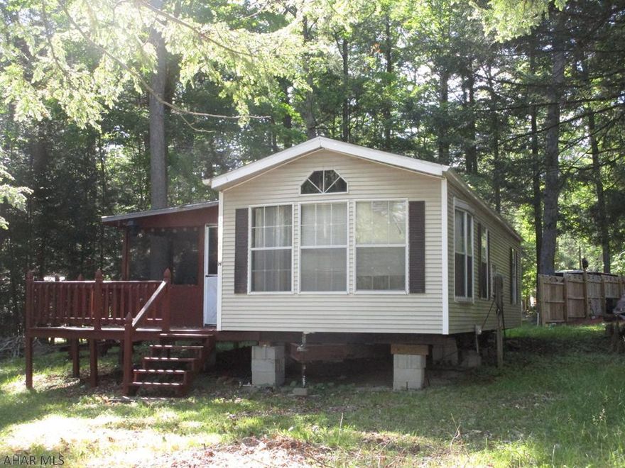 Park model camper with a screened in porch.  Two bedrooms, one a bunk room.  Unit needs some repairs.  Shed .  Seller has a golf cart for sale that is Not included with the property.  Unit has city water and sewer but there also a comfort station in Birch Circle.