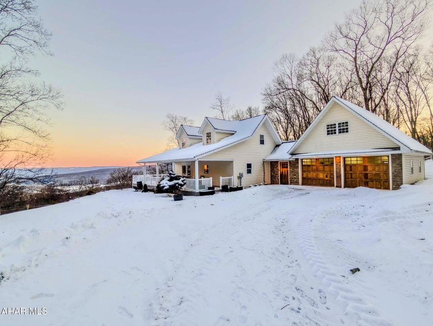 Perched to capture truly spectacular mountain views, this charming 3 bedroom, 3 bath Cape Cod offers the perfect blend of comfort, functionality, and peaceful country living. The inviting covered front porch and expansive side deck provide ideal spaces to relax, entertain, and take in the breathtaking scenery that surrounds the home. Inside, the open concept living and kitchen area creates a warm and welcoming atmosphere, centered around a cozy stone fireplace, beautiful granite countertops with peninsula seating, and stainless appliances. The second floor serves as a private master suite featuring an en suite bath with a soaking tub and a private balcony with stunning mountain views.  The fully finished basement expands the home's versatility and includes an additional living room, a cozy reading nook or bunk area, another bedroom, and a full bathroom, perfect for guests or extended family. A full bathroom on each level offers convenience and flexibility, while main level laundry and a two-car attached garage make everyday living easy and efficient. Outdoors, the property truly shines. A large barn, currently set up with horse stalls, offers endless possibilities for equestrian use, hobbies, or additional storage. Enjoy gardening in the raised beds, watch deer and turkeys roam the landscape, and experience the tranquility of nature right in your own backyard. Conveniently located with easy access to I 99, US 30, and the PA Turnpike, this exceptional property combines privacy, scenic beauty, and accessibility, making it a rare opportunity to enjoy mountain living without sacrificing convenience.