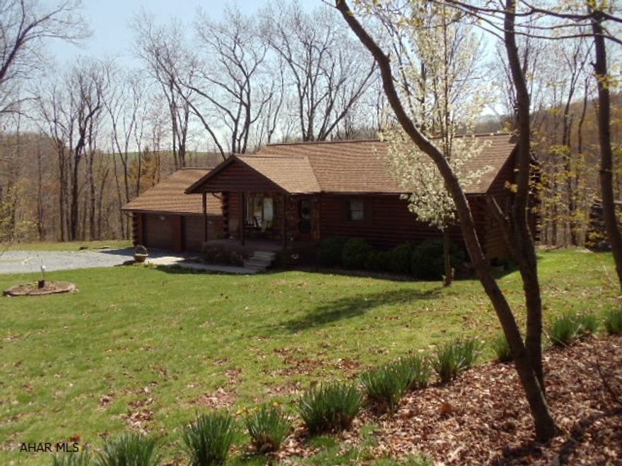 Lovely and spacious log home with 4 bedrooms, 2 baths,on 1.4 acre quiet wooded setting. New hardwood floors, finished basement with summer kitchen and family room. Oil and wood furnaces.  J-122