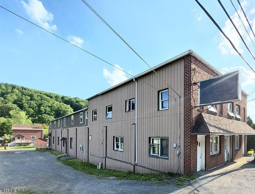 Check out this commercial building that offers the rarity of commercial space that could be used for storage, warehouse space, and heavy industry. This property features over 10,000 sq. feet, loading dock, and over a half acre plenty of room for trucks and equipment.  In addition, this property features 3 fully rented 2 bedroom apartments. Check out this investment property today.