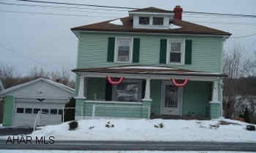 2 story block with vinyl siding, full basement partially finished, front & rear porch, and 1 car detached garage with basement.